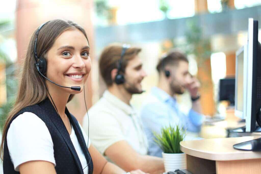 Positive young business people and colleagues in a call center office