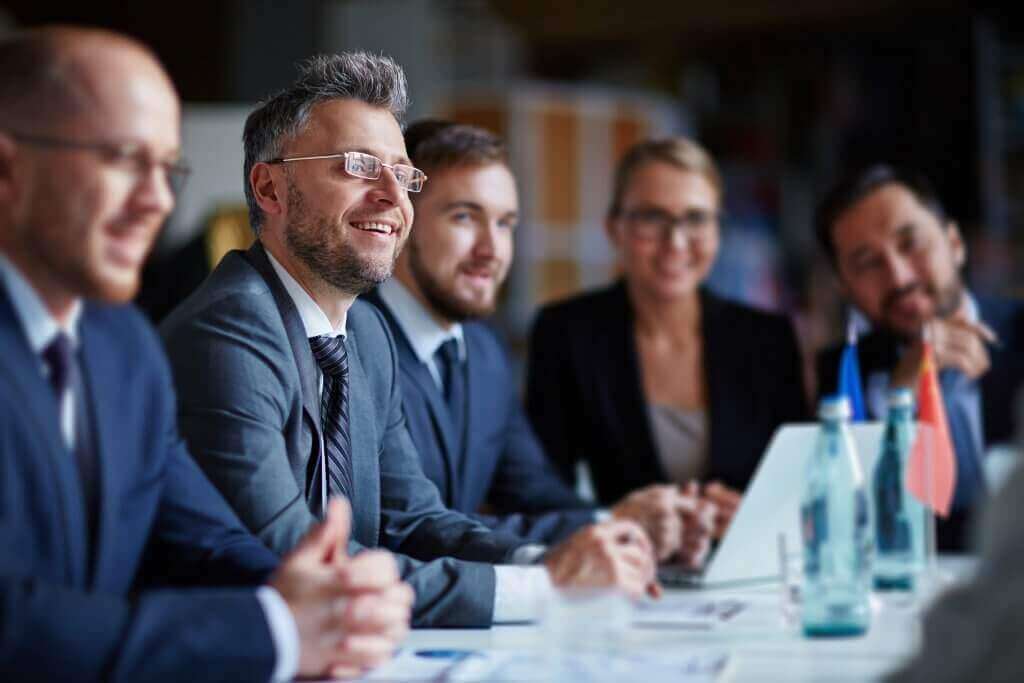 Successful businesspeople sitting at conference or seminar during lecture